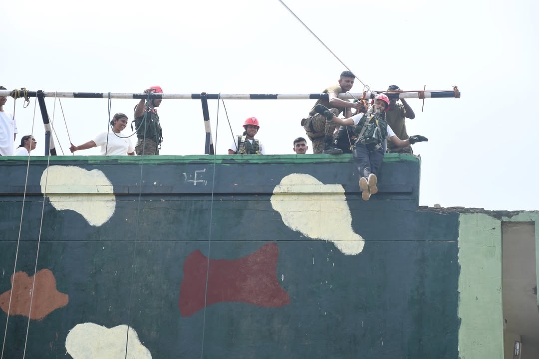 Awakeners tackling a rappelling obstacle under instructor supervision